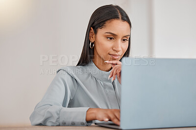 Buy stock photo Shot of a young businesswoman using a laptop in an office at work