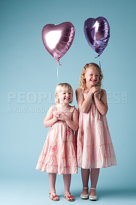 Buy stock photo Children, portrait and sister with heart balloon in studio on blue background for family or party. Birthday, celebration or smile with girl kid friends, happy on color backdrop together for event