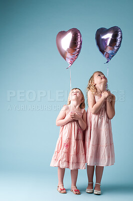 Buy stock photo Children, sister and space with heart balloon in studio on blue background for family or party. Celebration, mockup or smile with girl kids and love, happy at birthday together for break or event