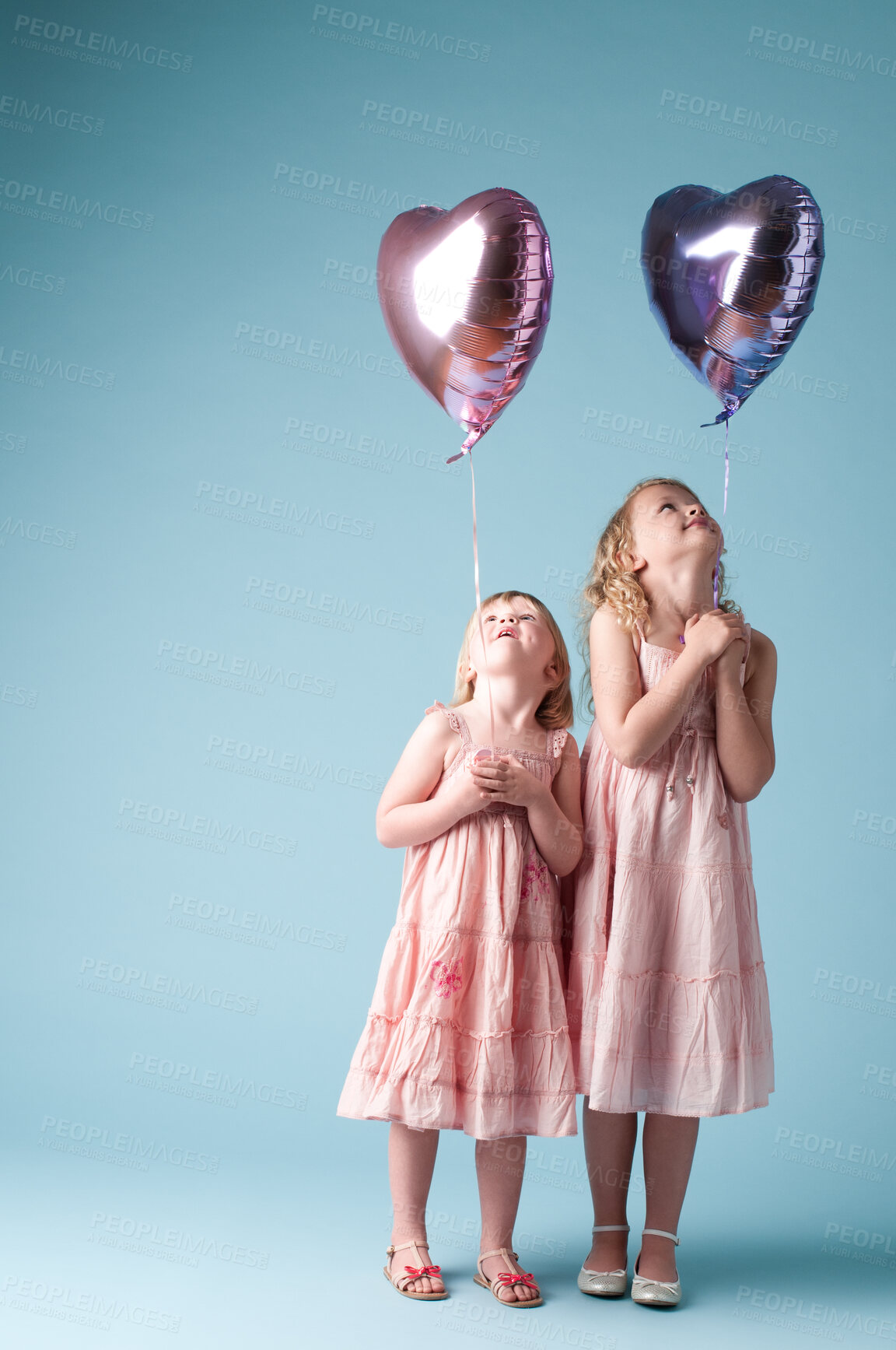 Buy stock photo Children, sister and space with heart balloon in studio on blue background for family or party. Celebration, mockup or smile with girl kids and love, happy at birthday together for break or event