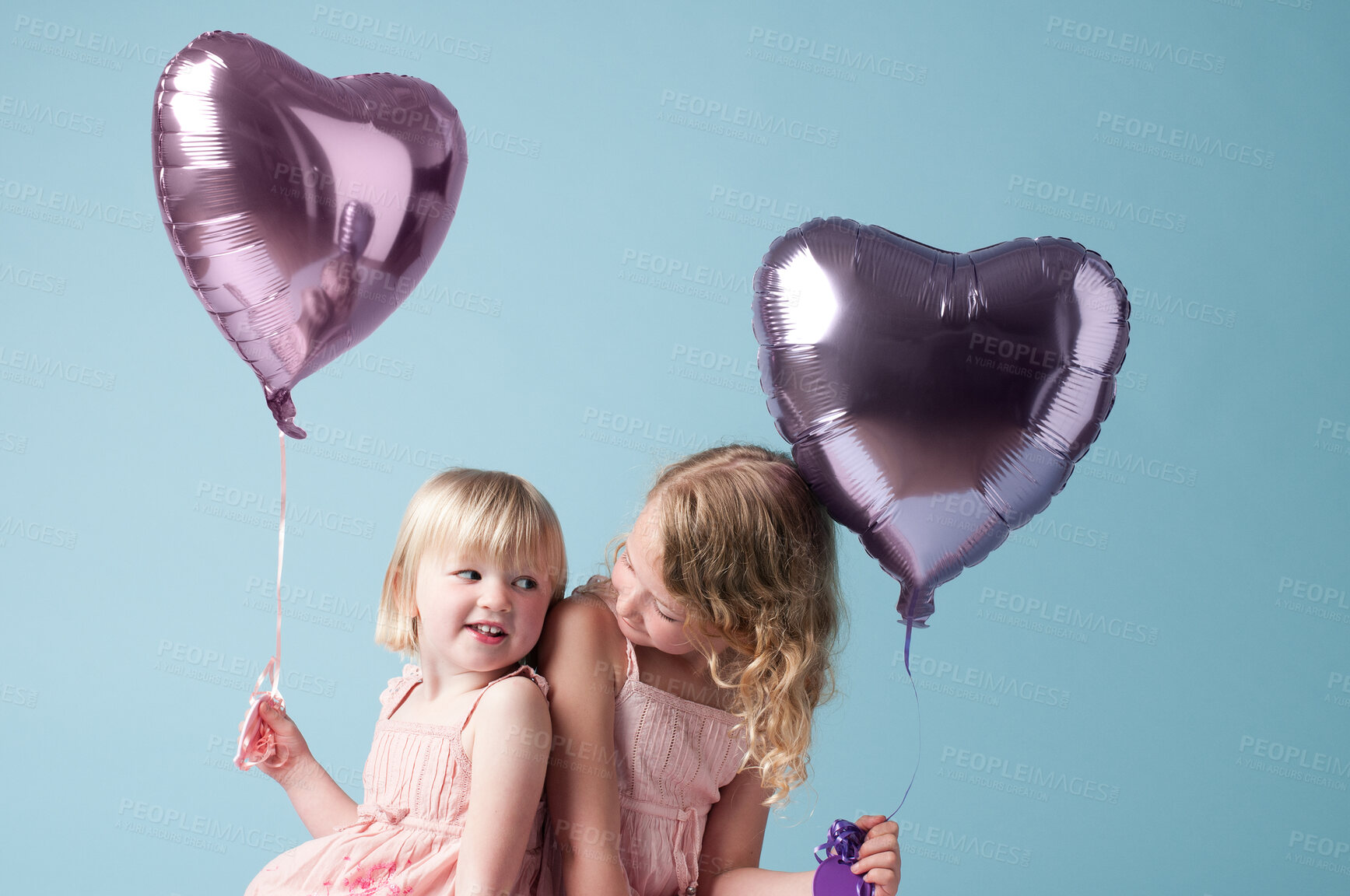 Buy stock photo Children, sister and together with heart balloon in studio on blue background for family or party. Birthday, bonding or celebration with smile of happy girl kid friends on color backdrop together