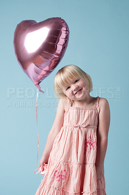 Buy stock photo Heart balloon, happy and portrait of young girl on studio background for mockup, birthday and love. Female child, celebration and smile by blue backdrop for event, party and holiday or festival