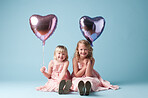 Two cute girls playing with balloons