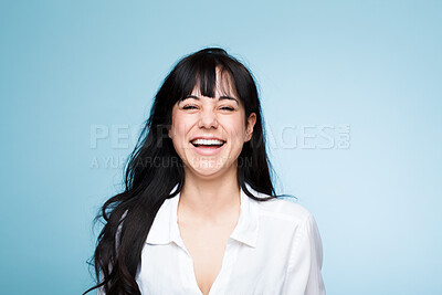 Buy stock photo Smile, laughing and portrait of a beautiful woman isolated on a blue background in a studio. Happy, young and a headshot of a girl in a shirt with confidence, empowerment and looking stylish