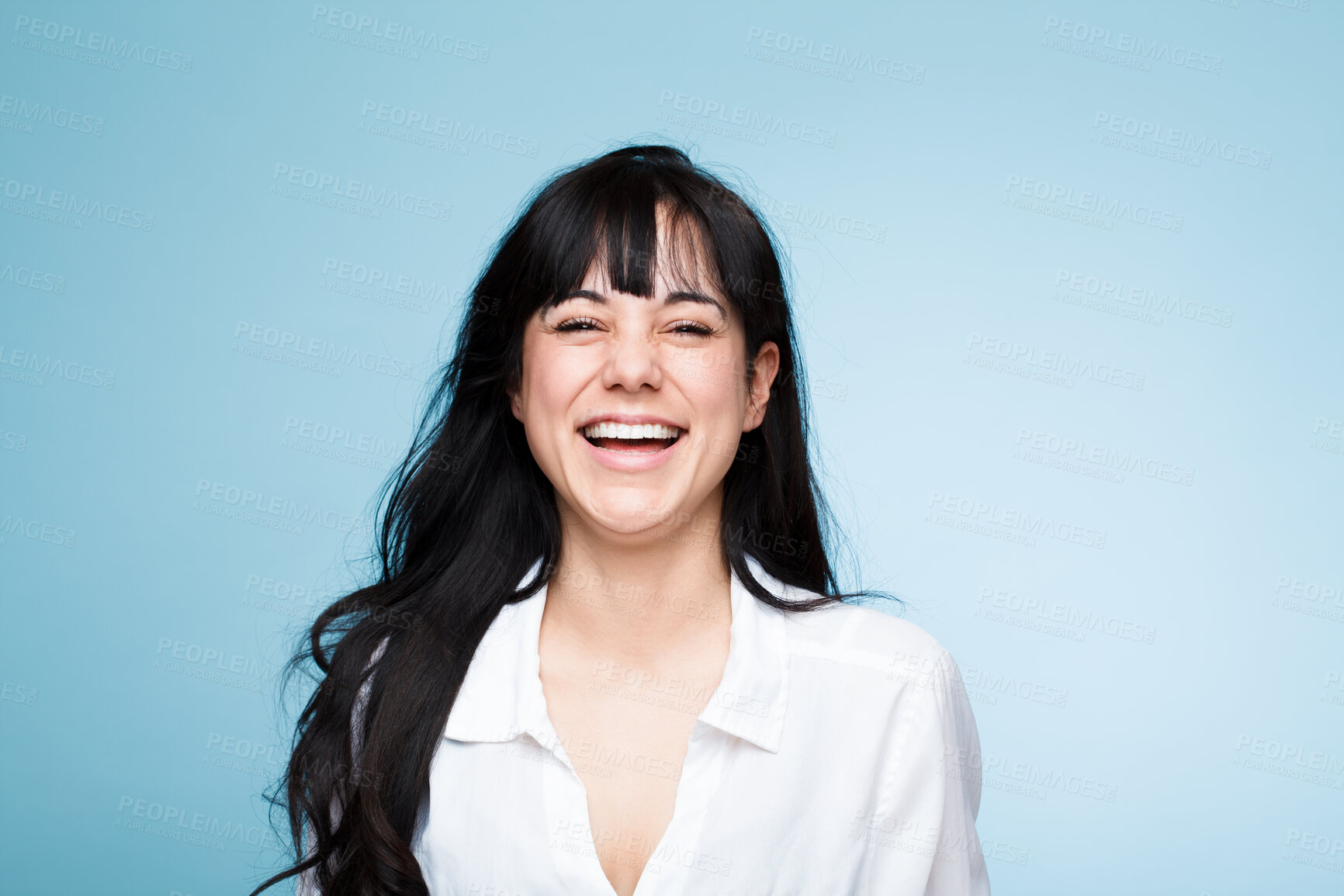 Buy stock photo Smile, laughing and portrait of a beautiful woman isolated on a blue background in a studio. Happy, young and a headshot of a girl in a shirt with confidence, empowerment and looking stylish