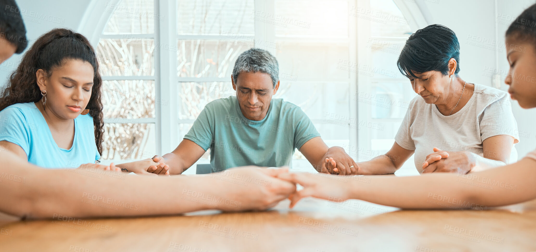 Buy stock photo Religion, family and holding hands for praying at table in home with worship, spiritual practice and gratitude. Christian people, parents and grandparents with children for praise to God and thankful