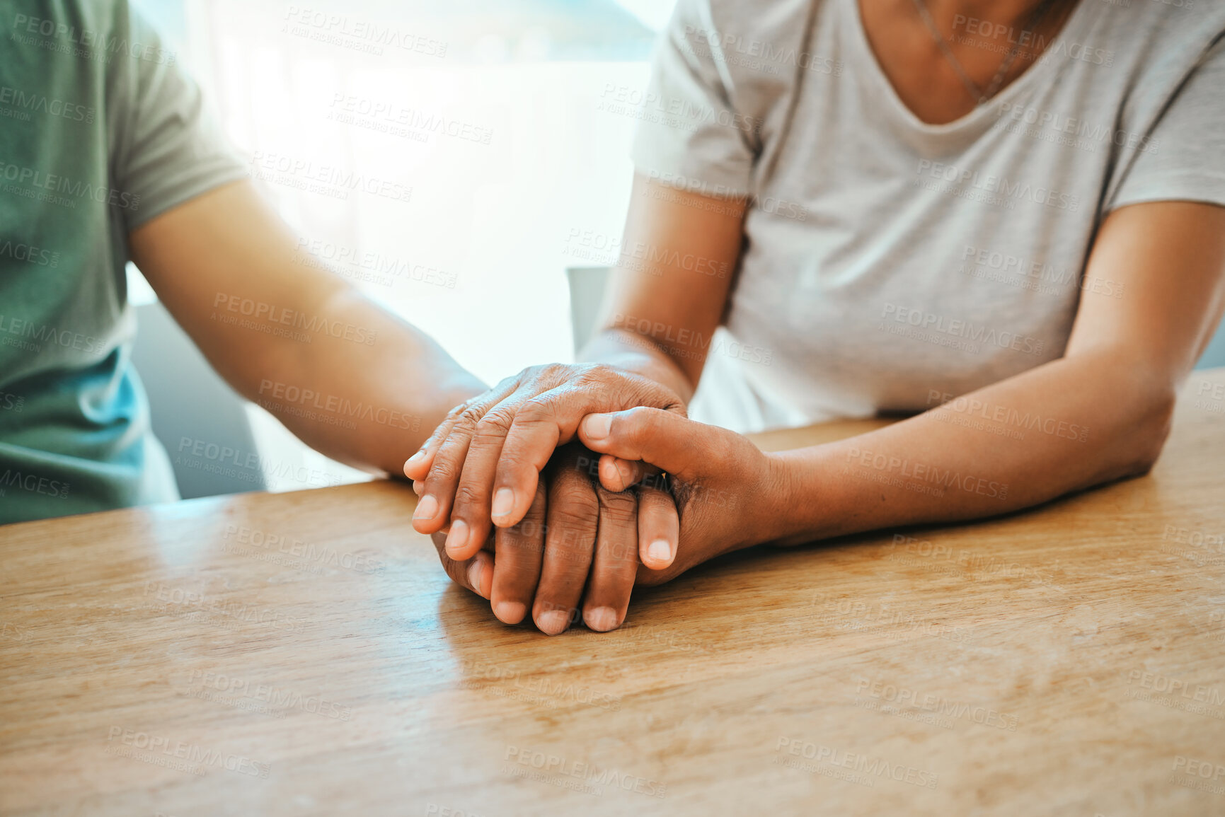 Buy stock photo Love, couple and holding hands for support, trust or empathy to help after dementia diagnosis. Comfort, man and woman with kindness for hope, commitment or connection together on wooden table at home