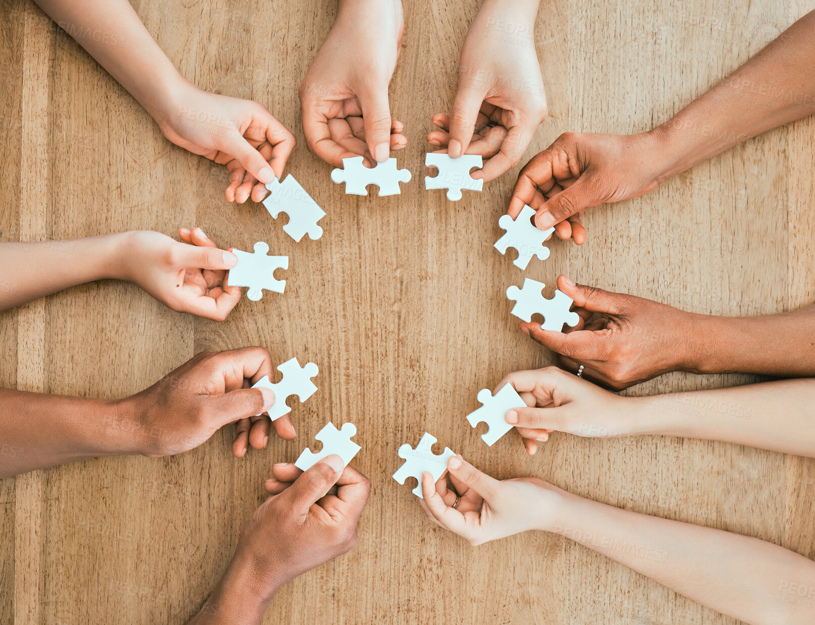 Buy stock photo Shot of a family building a puzzle together at home