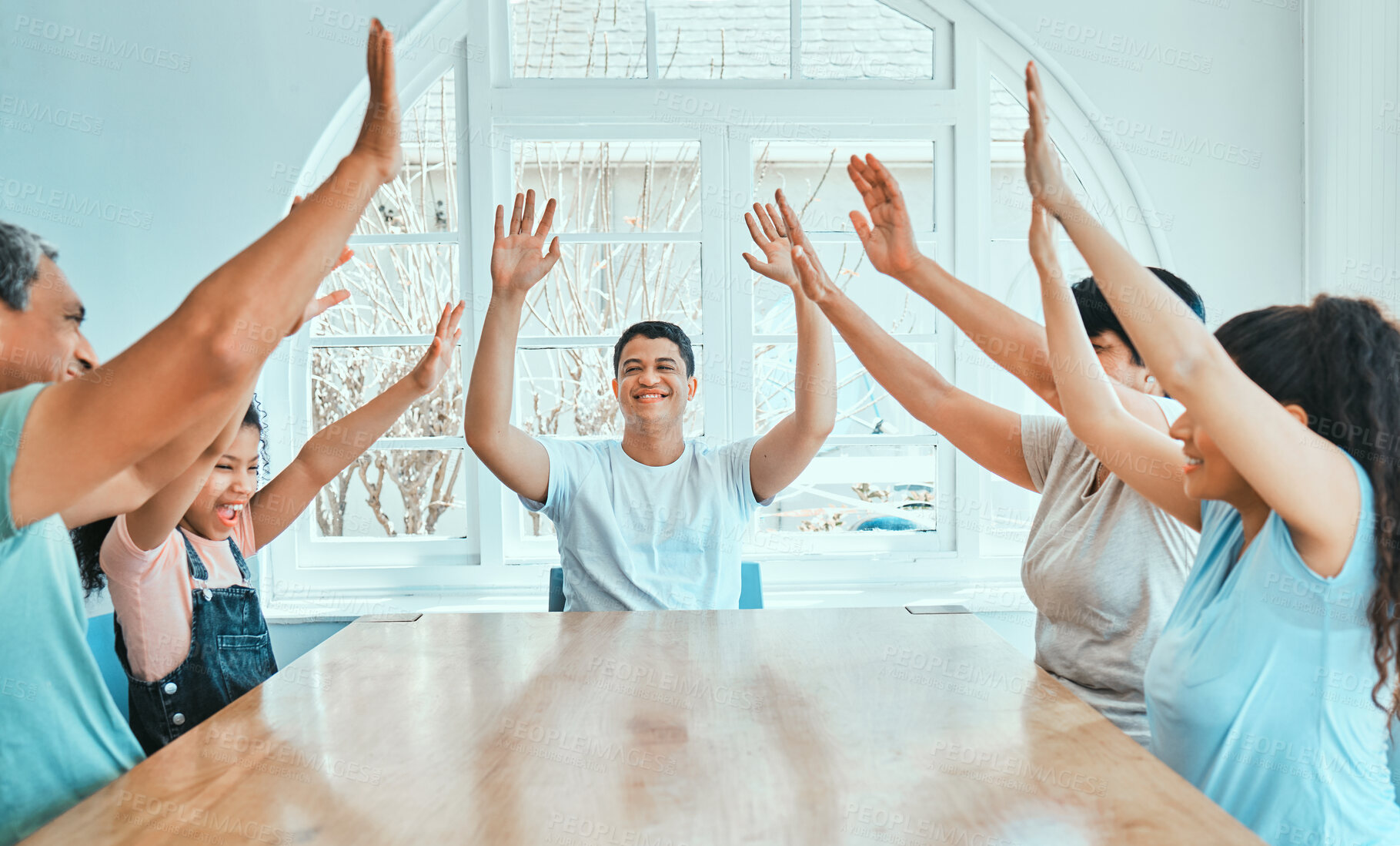 Buy stock photo Family, table and high five in house for celebration, solidarity and bonding with fun social game. Generations, people and arms raised in living room for achievement, relationship or leisure together