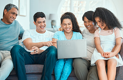 Buy stock photo Shot of a beautiful family using a laptop while bonding on a sofa at home