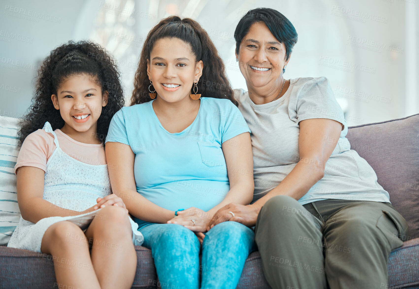 Buy stock photo Shot of a mature woman bonding with her daughter and granddaughter on a sofa at home