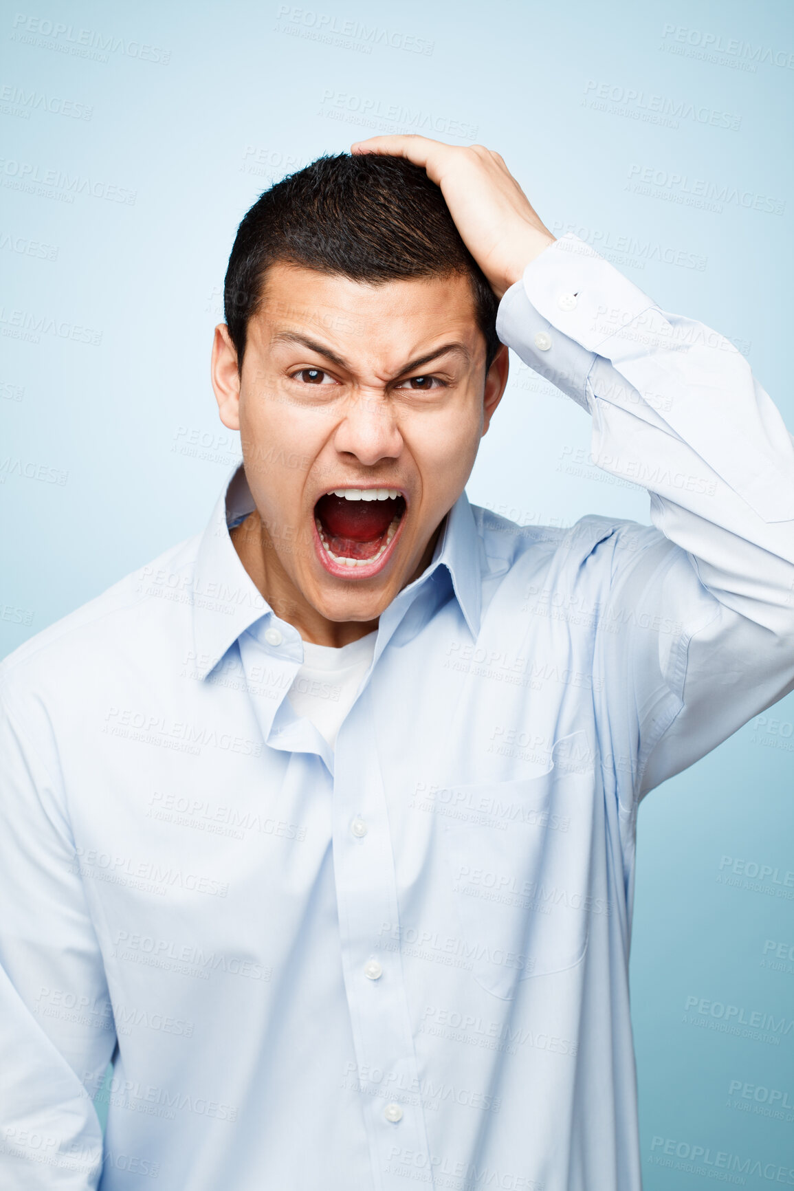 Buy stock photo Portrait, screaming and man with surprise, stress and expression on blue studio background. Face, person and model with emotion, shouting and frustrated with reaction, shocked and upset with anger