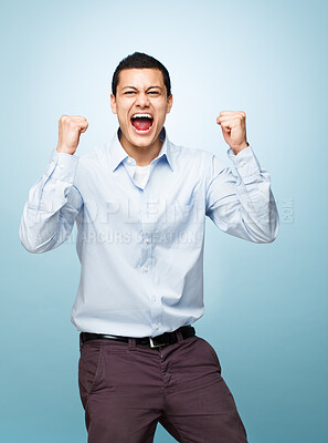 Buy stock photo Portrait, screaming and man with surprise, celebration and expression on blue studio background. Face, person and model with achievement, shouting or wow with winner, promotion or giveaway with smile