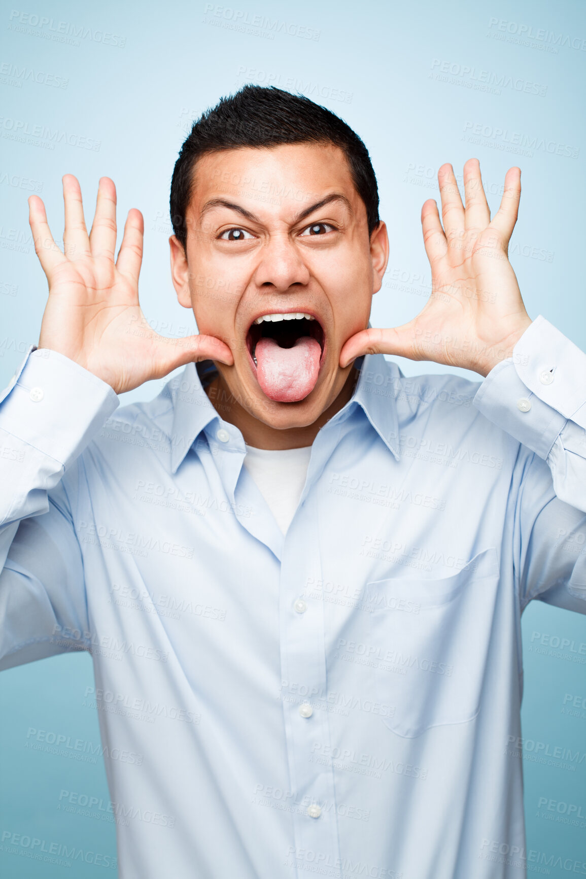 Buy stock photo Funny, tongue out and portrait of businessman in studio for crazy, comic or comedy joke with personality. Happy, humor and male person with silly or goofy face expression isolated by blue background.