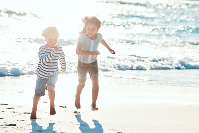Buy stock photo Shot of an adorable little girl and boy having fun at the beach