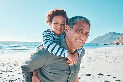 Buy stock photo Shot of a little boy spending the day at the beach with his grandfather