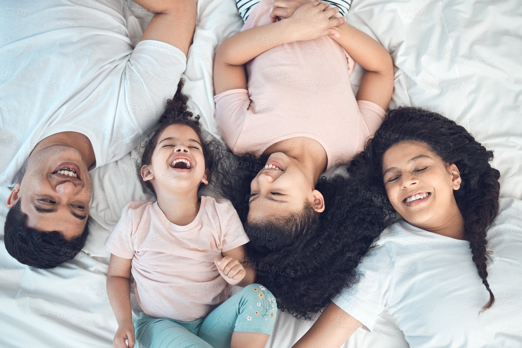 Buy stock photo Bed, happy and above of parents and kids for relax, rest and comfortable in morning. Family, home and top view of mother, father and children in bedroom for bonding, relationship or laughing together