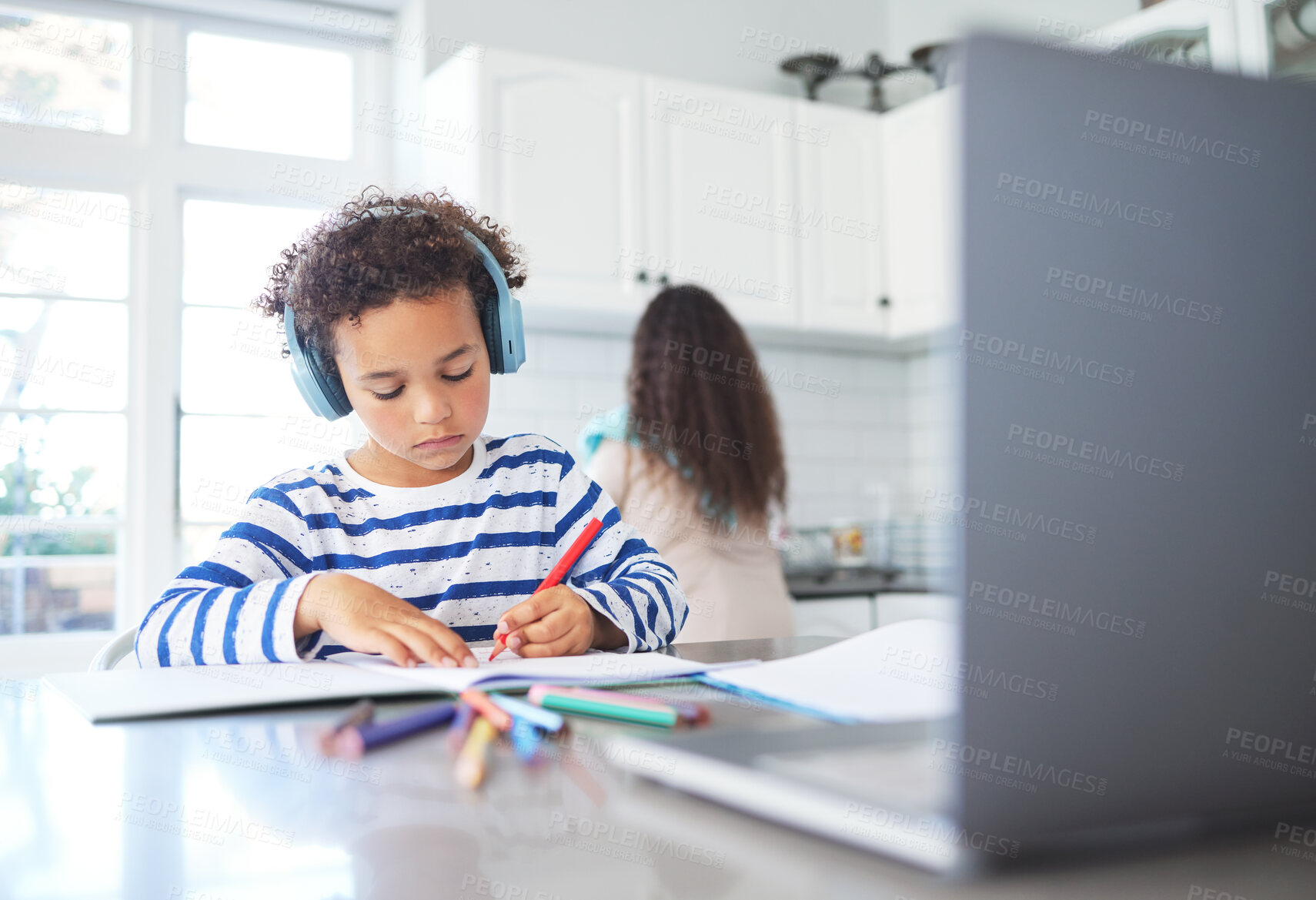 Buy stock photo Shot of a little boy doing his homework at home