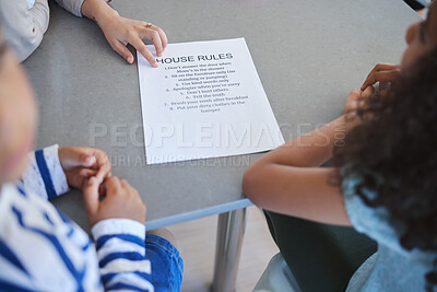 Buy stock photo Shot of an unrecognizable woman explaining a list of chores to her kids at home