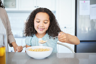 Buy stock photo Shot of an adorable little girl having breakfast at the kitchen table