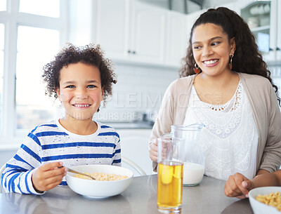 Buy stock photo Shot of a mother and son having breakfast at the kitchen table at home