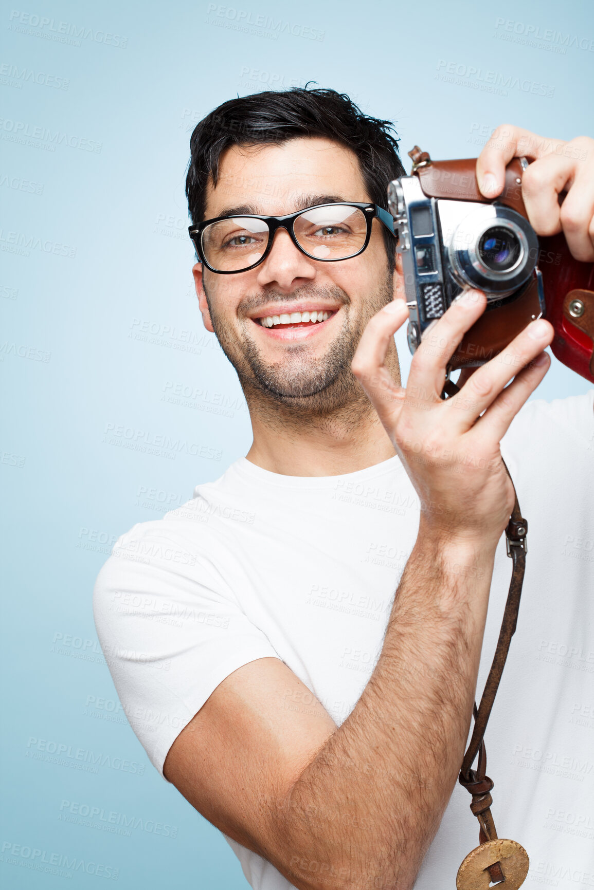 Buy stock photo Portrait, man and photographer with camera in studio for picture, creative media and memory as artistic session. Smile, male paparazzi and vintage digital tech for production film on blue background