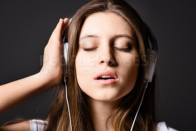 Buy stock photo Studio background, woman and headphones for music to listen with peaceful audio, radio app or online playlist. Girl, gen z and tech for sound track with podcast, streaming song and media subscription