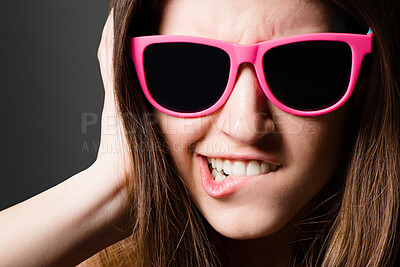 Buy stock photo Black background, funny face and girl with sunglasses, studio and style of Gen z, fashion and accessory. Confidence, crazy and person with eyewear, color and trendy in weekend, shades and portrait