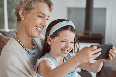 Buy stock photo Selfie, happy and grandmother with child in home for bonding, connection and family time. Smile, love and girl kid with senior woman for photography picture together in living room at house in Canada