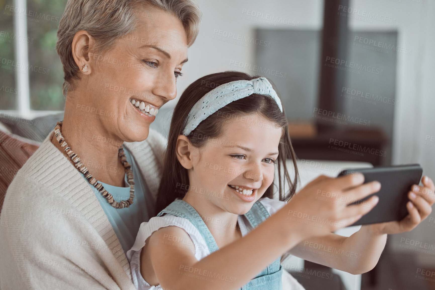 Buy stock photo Selfie, happy and grandmother with child in home for bonding, connection and family time. Smile, love and girl kid with senior woman for photography picture together in living room at house in Canada