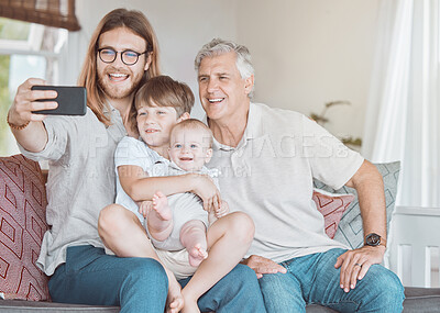 Buy stock photo Shot of a mature man taking a a selfie with his son and grandkids at home