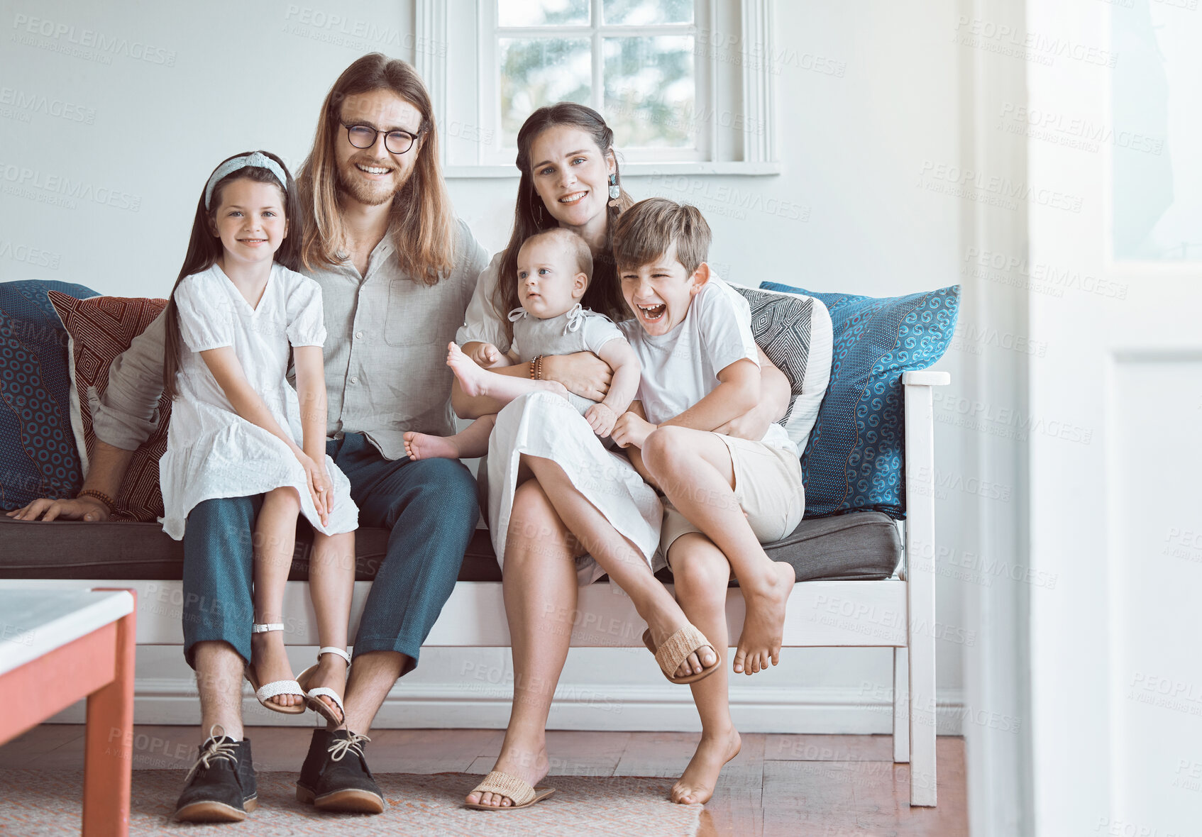 Buy stock photo Parents, kids and portrait on sofa in home with embrace, bonding and security with smile in lounge. Happy family, people and children on couch with relax, support and love with care in living room