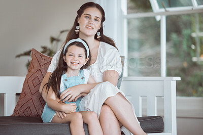 Buy stock photo Happy, mom and kid in home for portrait, comfort and support on weekend in Canada, Smile, mother and daughter in living room with hug, relax and bonding with care and security in family with love