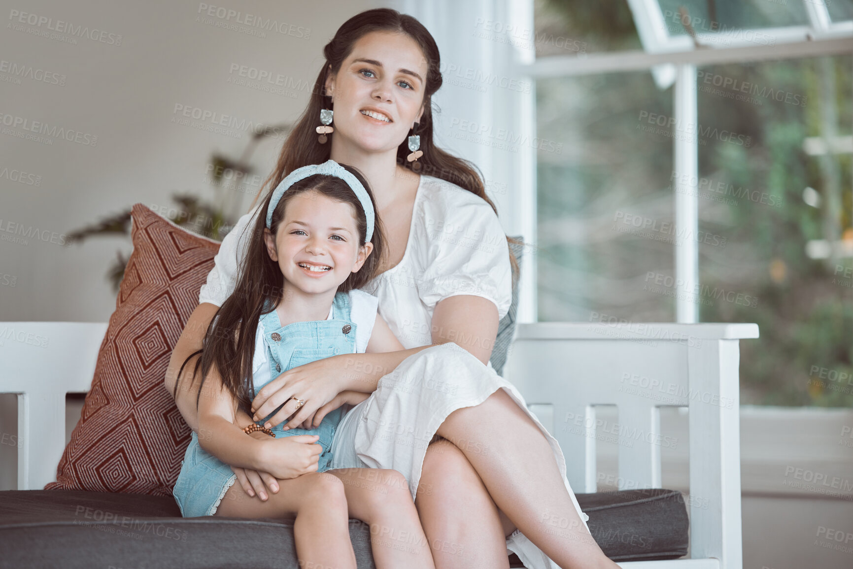 Buy stock photo Happy, mom and kid in home for portrait, comfort and support on weekend in Canada, Smile, mother and daughter in living room with hug, relax and bonding with care and security in family with love