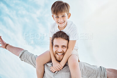 Buy stock photo Shot of a young father and son spending time together at the beach