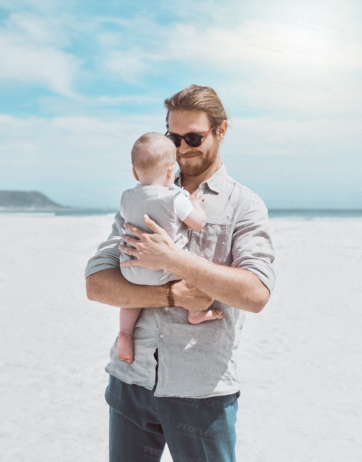 Buy stock photo Beach, happy and dad with baby in nature for playing on holiday, vacation and adventure. Family, outdoor and kid with father embrace by ocean for bonding, loving relationship and fun in Australia