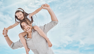 Buy stock photo Shot of a young father and daughter spending time together at the beach
