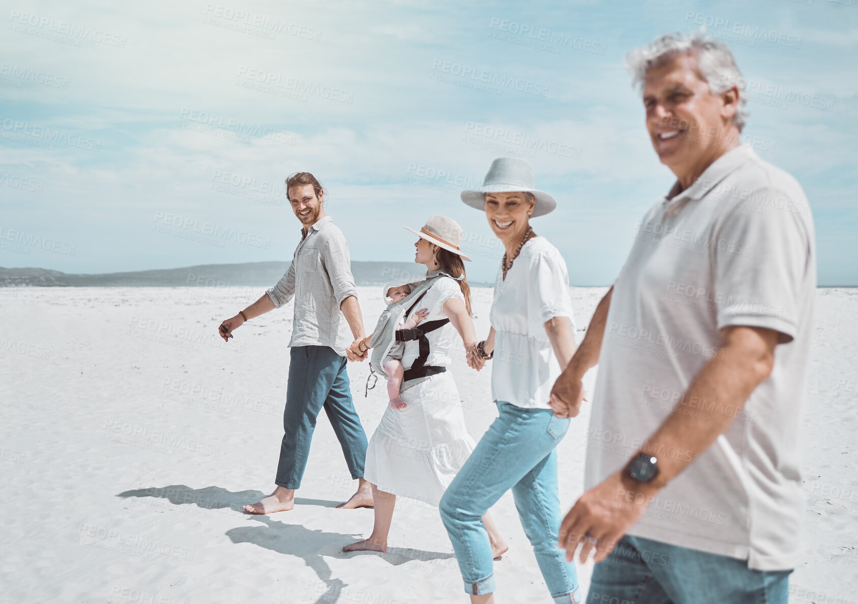 Buy stock photo Generations, family and holding hands at ocean with travel, smile and bonding on holiday together. Grandparents, parents and baby on beach vacation with happy people on outdoor adventure in Australia