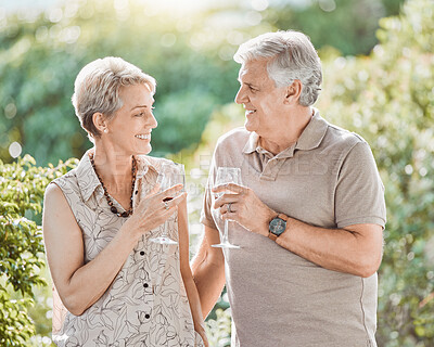 Buy stock photo Shot of a mature couple enjoying a glass of wine outside