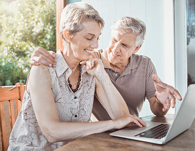 Buy stock photo Shot of a mature couple using a laptop while sitting outside