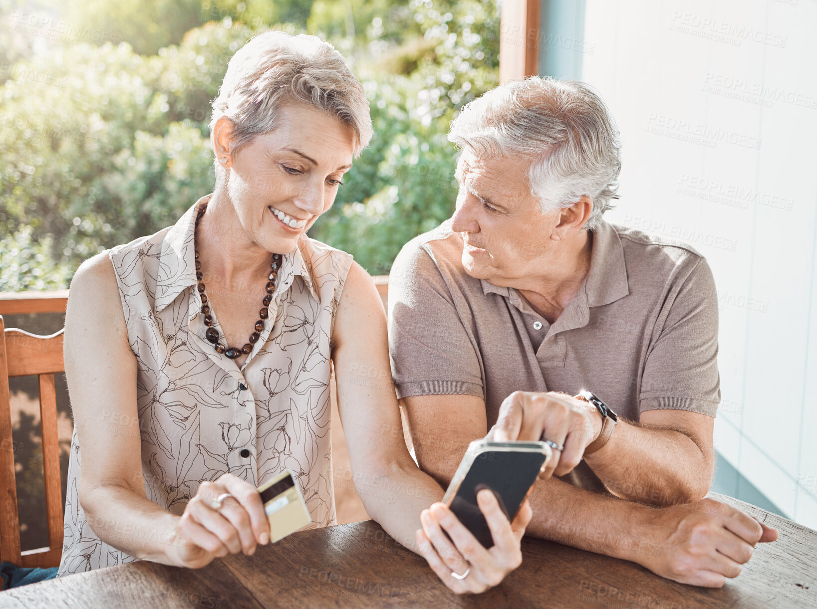 Buy stock photo Phone, credit card and senior couple in home with travel planning, booking or email review. Smartphone, old man and happy woman on patio with online shopping for retirement holiday on website