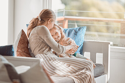 Buy stock photo Shot of a young woman bonding with her daughter at home