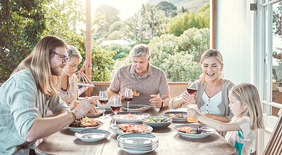 Buy stock photo Shot of a family sitting together and enjoying lunch