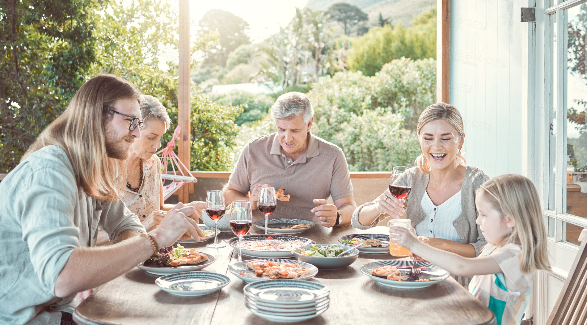 Buy stock photo Lunch, bonding and family at table sharing food, smile and weekend gathering event on patio. Grandparents, parents and girl child on terrace eating together for happy dinner celebration at home