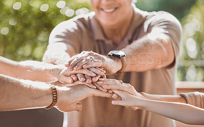 Buy stock photo Cropped shot of an unrecognisable family sitting together with their hands stacked in the middle