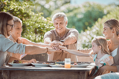 Buy stock photo Shot of a family sitting together with their hands stacked in the middle