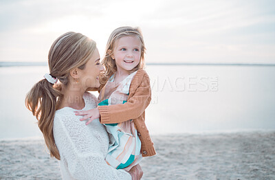 Buy stock photo Shot of a little girl spending the day at the beach with her mother