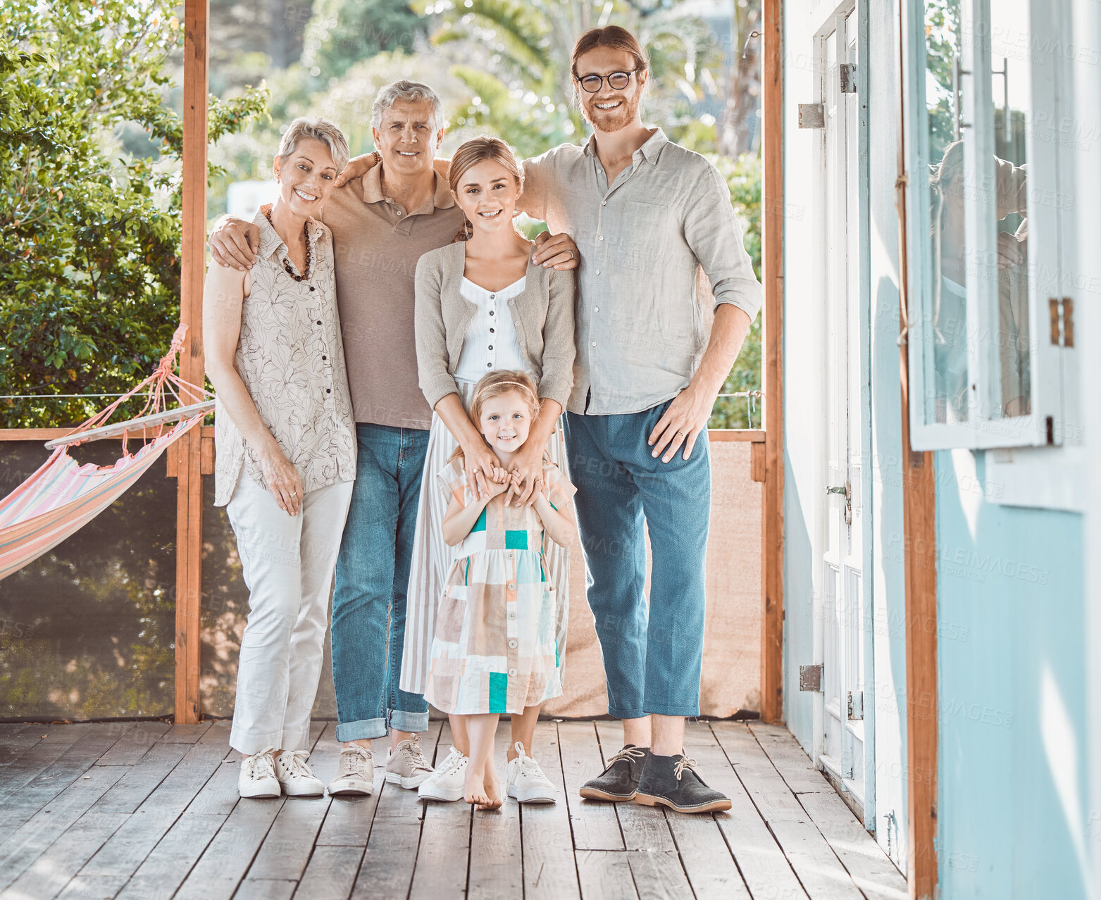 Buy stock photo Happy, big family and portrait with daughter for bonding, holiday or weekend together on outdoor porch at home. Grandparents, parents and young kid with smile for childhood, love or support at house