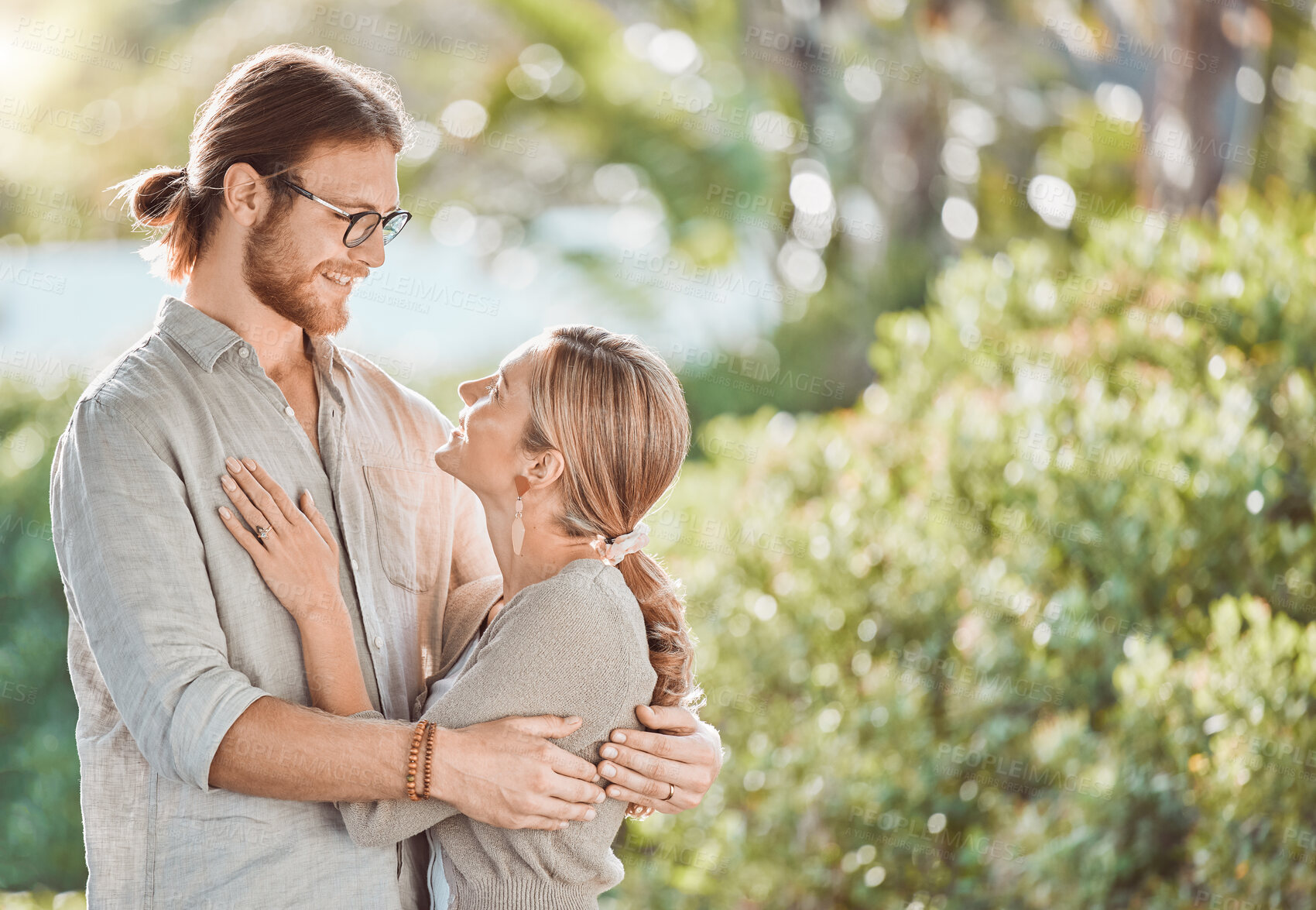 Buy stock photo Couple, hug and happy with love in garden with care, bonding and outdoor in spring for connection. People, man and woman in embrace, together or smile in backyard for eye contact by trees in Croatia