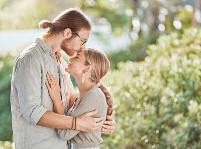 Buy stock photo Couple, hug and kiss forehead in garden with care, bonding and outdoor in spring for connection. People, man and woman in embrace, together and happy with love in backyard for profile in Croatia